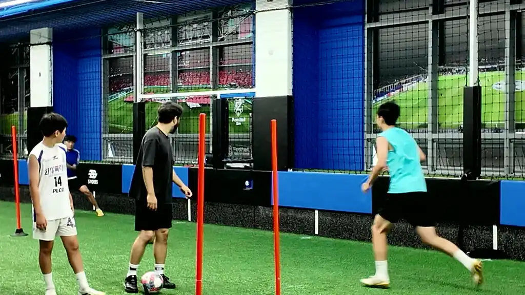 Young player training with real balls and equipment at FootballZon Anyang Academy